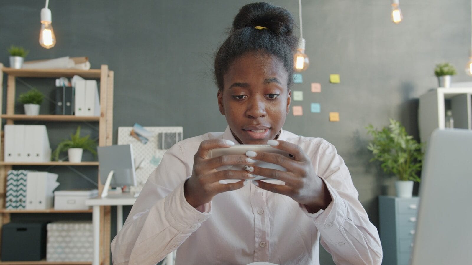 Young woman playing a game on her phone.