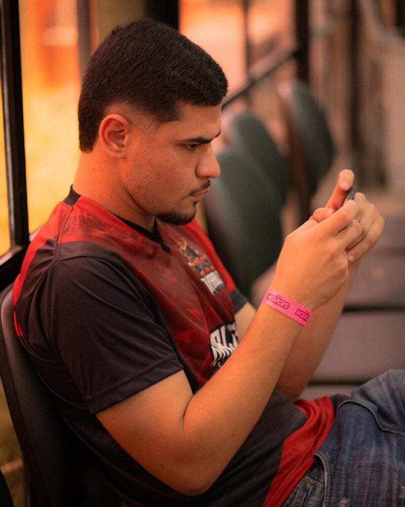 Young man in red shirt looking at phone